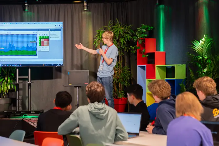 A student presenting a level he built in a game editor