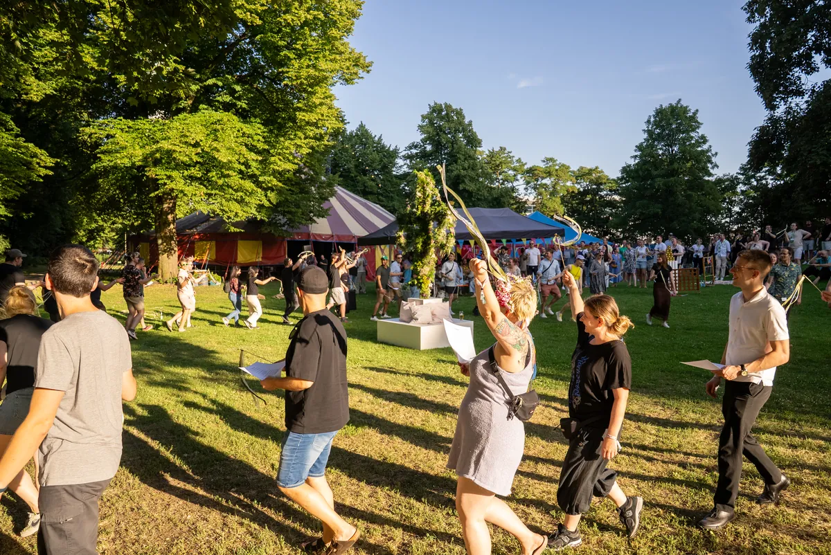 Colleagues dancing with ribbons at the InnoGames summer party